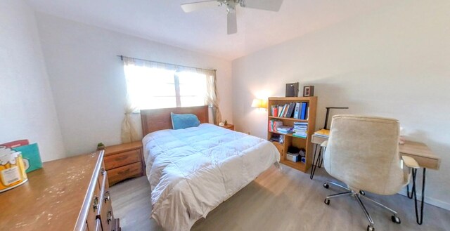 bedroom with wood finished floors and a ceiling fan
