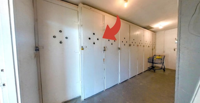 hallway with unfinished concrete floors