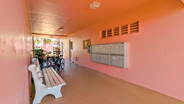 hall with mail area and finished concrete floors