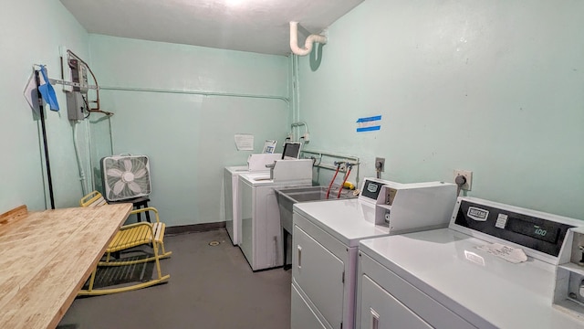 community laundry featuring separate washer and dryer