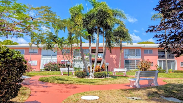 view of home's community with a yard