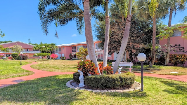 view of home's community with a yard