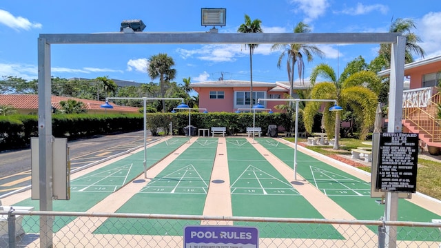 surrounding community featuring fence and shuffleboard