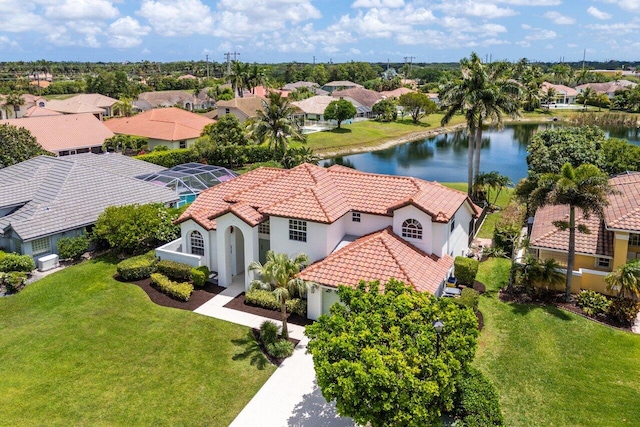 aerial view of residential area featuring a large body of water
