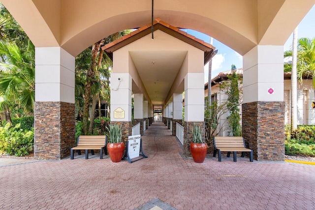entrance to property featuring stucco siding and stone siding