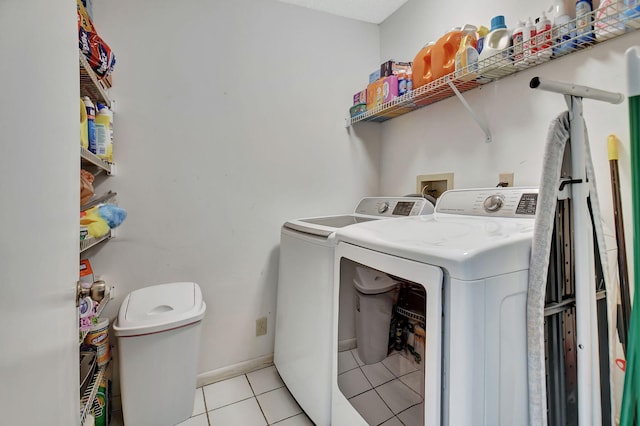 6235 Kings Gate Cir Unit C, Delray Beach, FL 33484 - laundry room featuring independent washer and dryer, light tile patterned floors, and baseboards
