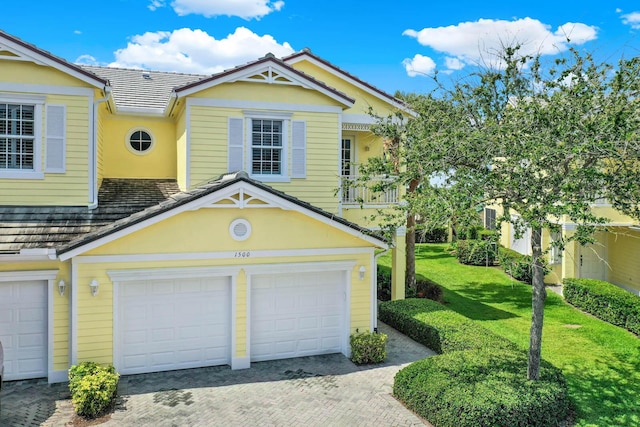 1500 Mariner Bay Blvd Unit 1500, Fort Pierce, FL 34949 - view of front of house with a garage, decorative driveway, a front yard, and stucco siding