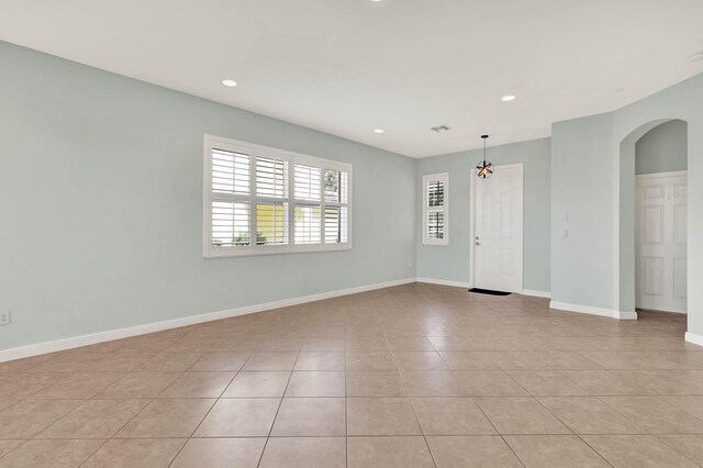 1500 Mariner Bay Blvd Unit 1500, Fort Pierce, FL 34949 - spare room featuring arched walkways, light tile patterned floors, baseboards, and recessed lighting