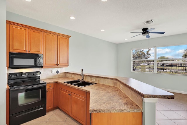 1500 Mariner Bay Blvd Unit 1500, Fort Pierce, FL 34949 - kitchen with black appliances, a sink, a peninsula, light tile patterned flooring, and decorative backsplash