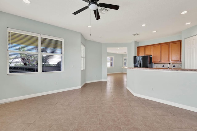 1500 Mariner Bay Blvd Unit 1500, Fort Pierce, FL 34949 - kitchen with black refrigerator with ice dispenser, light tile patterned flooring, brown cabinetry, recessed lighting, and ceiling fan