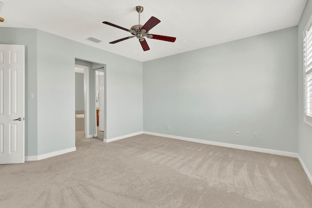1500 Mariner Bay Blvd Unit 1500, Fort Pierce, FL 34949 - unfurnished bedroom featuring carpet floors, baseboards, a ceiling fan, and connected bathroom