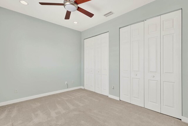 1500 Mariner Bay Blvd Unit 1500, Fort Pierce, FL 34949 - unfurnished bedroom featuring multiple closets, carpet flooring, baseboards, recessed lighting, and a ceiling fan
