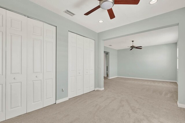 1500 Mariner Bay Blvd Unit 1500, Fort Pierce, FL 34949 - unfurnished bedroom featuring carpet flooring, two closets, baseboards, recessed lighting, and ceiling fan