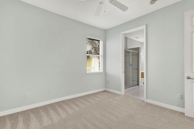 1500 Mariner Bay Blvd Unit 1500, Fort Pierce, FL 34949 - unfurnished bedroom featuring light colored carpet, baseboards, ensuite bathroom, and ceiling fan