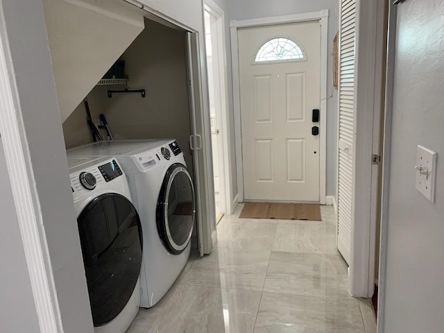 laundry room with light marble finish floors and separate washer and dryer