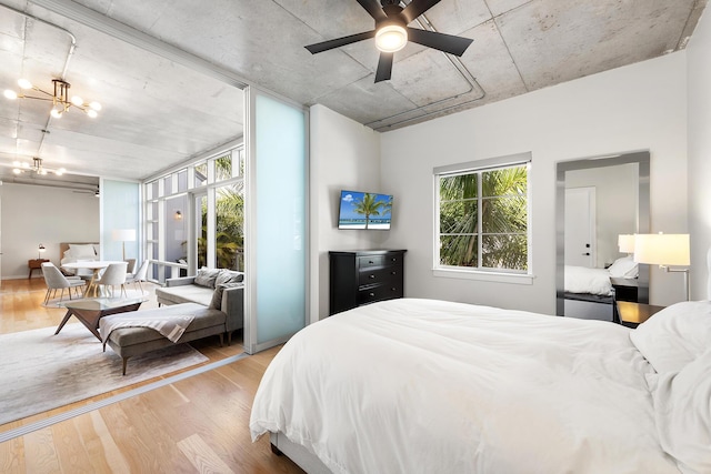 bedroom with an inviting chandelier and wood finished floors