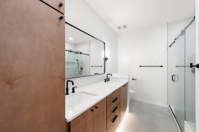 bathroom with visible vents, baseboards, a stall shower, and a sink