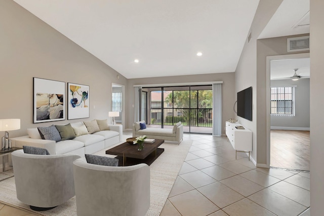 living room featuring vaulted ceiling, plenty of natural light, light tile patterned floors, baseboards, and recessed lighting