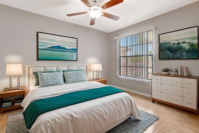 bedroom with baseboards, ceiling fan, and light tile patterned flooring