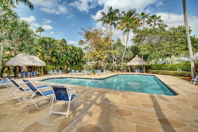 community pool with a gazebo and a patio area