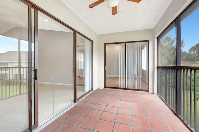 unfurnished sunroom featuring a ceiling fan