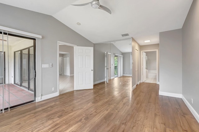 unfurnished living room featuring ceiling fan, lofted ceiling, wood finished floors, and baseboards