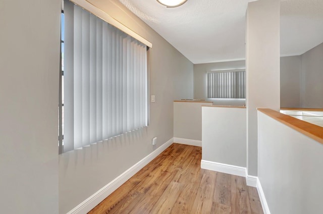 unfurnished room with wood finished floors and baseboards