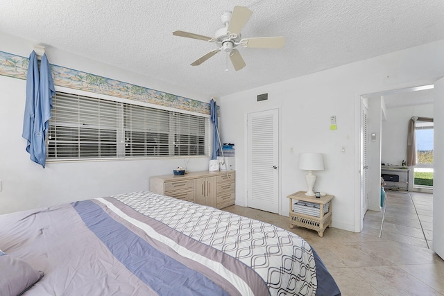 1470 S Ocean Blvd Unit 1201, Lauderdale By The Sea, FL 33062 - bedroom with a textured ceiling, light tile patterned floors, and a ceiling fan