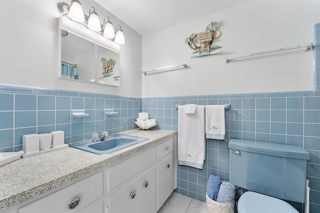 1470 S Ocean Blvd Unit 1201, Lauderdale By The Sea, FL 33062 - bathroom with tile walls, toilet, tile patterned floors, wainscoting, and vanity