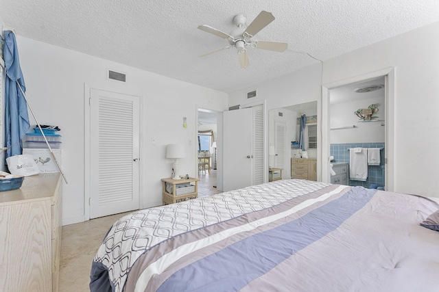 1470 S Ocean Blvd Unit 1201, Lauderdale By The Sea, FL 33062 - bedroom featuring a textured ceiling, light tile patterned floors, connected bathroom, and ceiling fan