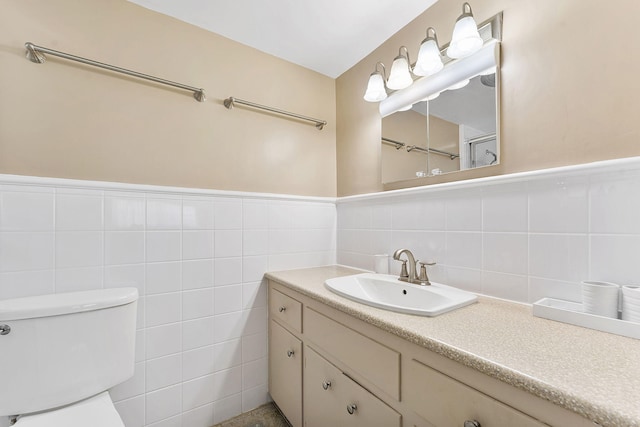 1470 S Ocean Blvd Unit 1201, Lauderdale By The Sea, FL 33062 - bathroom featuring toilet, vanity, tile walls, and wainscoting