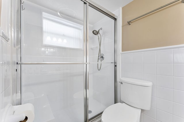 1470 S Ocean Blvd Unit 1201, Lauderdale By The Sea, FL 33062 - full bath featuring toilet, a stall shower, tile walls, and wainscoting