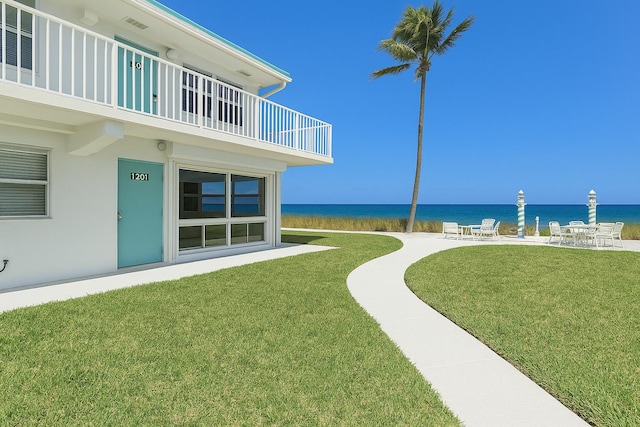 1470 S Ocean Blvd Unit 1201, Lauderdale By The Sea, FL 33062 - view of green lawn featuring a water view, a balcony, and a patio area