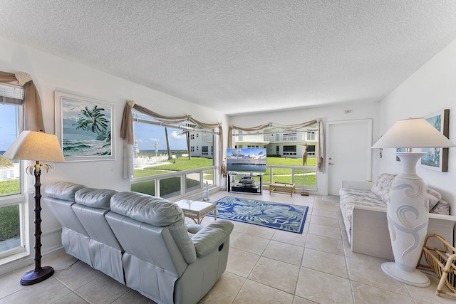 1470 S Ocean Blvd Unit 1201, Lauderdale By The Sea, FL 33062 - living room with light tile patterned floors and a textured ceiling