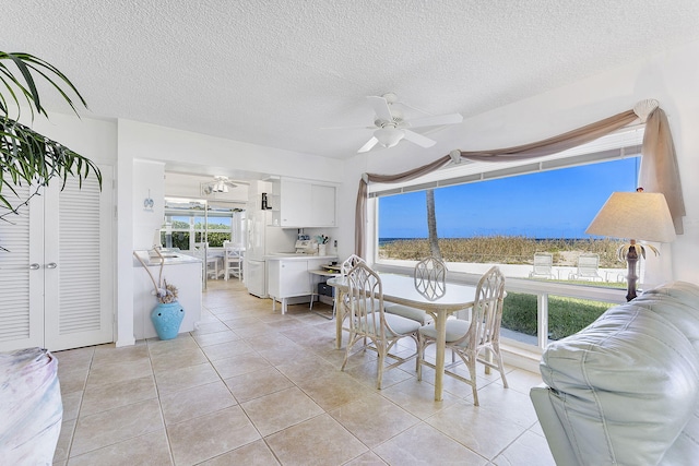 1470 S Ocean Blvd Unit 1201, Lauderdale By The Sea, FL 33062 - dining room with a textured ceiling, a ceiling fan, and light tile patterned floors