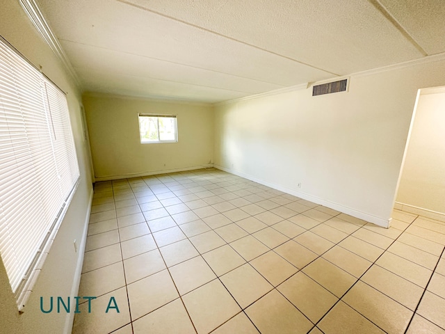 817 Lighthouse Dr Unit A, B, C, D, North Palm Beach, FL 33408 - spare room with ornamental molding, light tile patterned floors, baseboards, and a textured ceiling