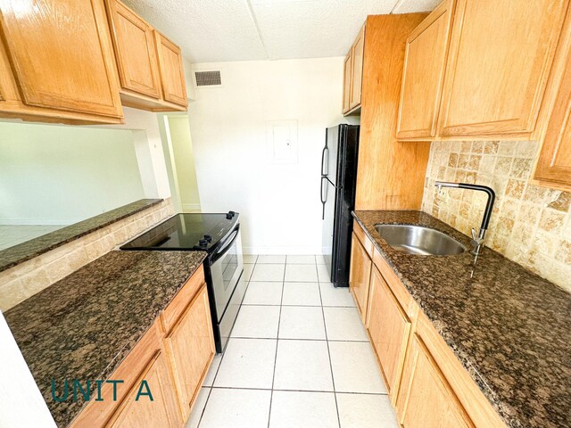 817 Lighthouse Dr Unit A, B, C, D, North Palm Beach, FL 33408 - kitchen with a sink, stainless steel electric stove, freestanding refrigerator, backsplash, and light brown cabinets