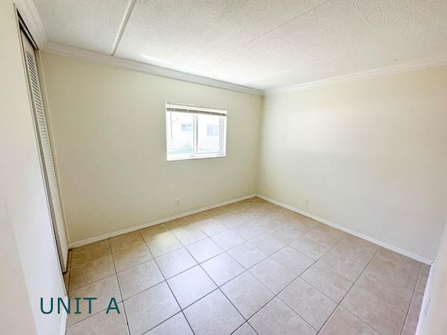 817 Lighthouse Dr Unit A, B, C, D, North Palm Beach, FL 33408 - empty room with light tile patterned floors, ornamental molding, and baseboards
