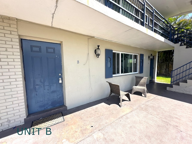 817 Lighthouse Dr Unit A, B, C, D, North Palm Beach, FL 33408 - view of exterior entry with stucco siding and a patio
