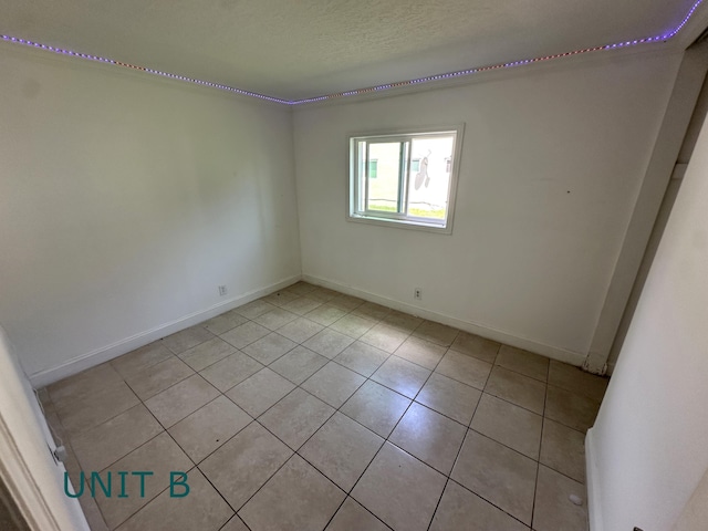 817 Lighthouse Dr Unit A, B, C, D, North Palm Beach, FL 33408 - spare room with light tile patterned floors, baseboards, and a textured ceiling