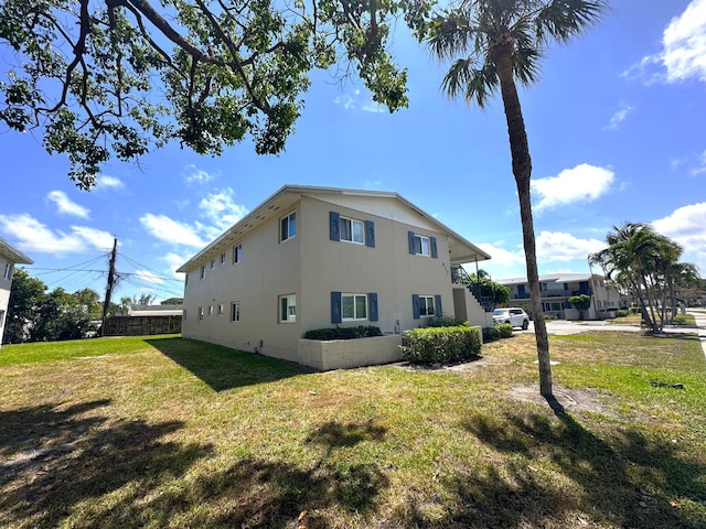 817 Lighthouse Dr Unit A, B, C, D, North Palm Beach, FL 33408 - view of side of property with stucco siding and a lawn