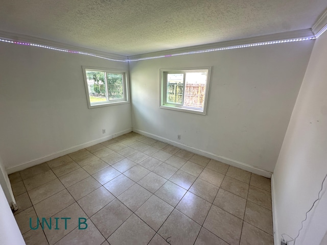 817 Lighthouse Dr Unit A, B, C, D, North Palm Beach, FL 33408 - empty room with a textured ceiling, tile patterned flooring, ornamental molding, and baseboards