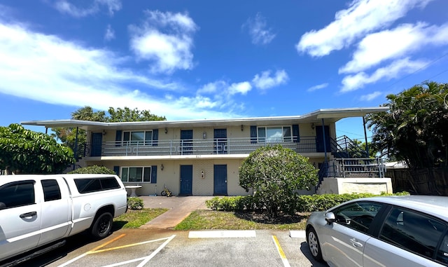 817 Lighthouse Dr Unit A, B, C, D, North Palm Beach, FL 33408 - view of front of property with uncovered parking, stairway, and stucco siding