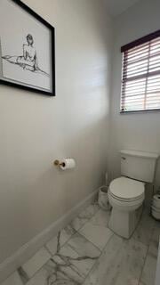 203 Evergrene Pkwy, Palm Beach Gardens, FL 33410 - half bathroom featuring toilet and baseboards