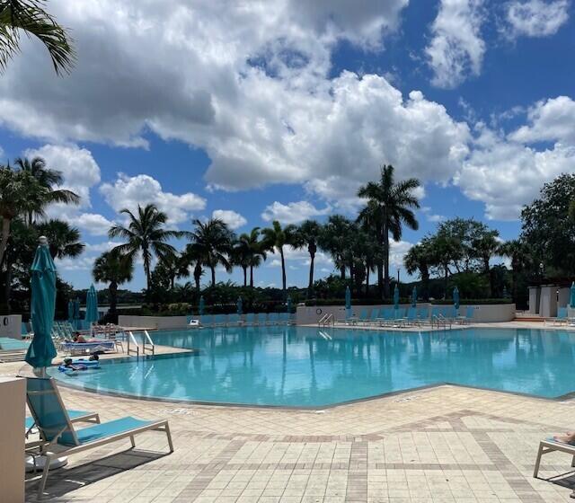 203 Evergrene Pkwy, Palm Beach Gardens, FL 33410 - community pool featuring a patio