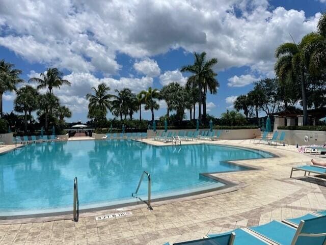 203 Evergrene Pkwy, Palm Beach Gardens, FL 33410 - community pool featuring a patio