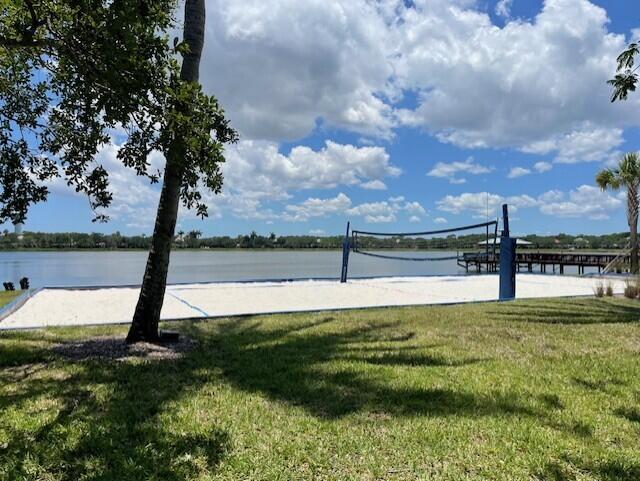 203 Evergrene Pkwy, Palm Beach Gardens, FL 33410 - view of home's community with volleyball court, a lawn, and a water view