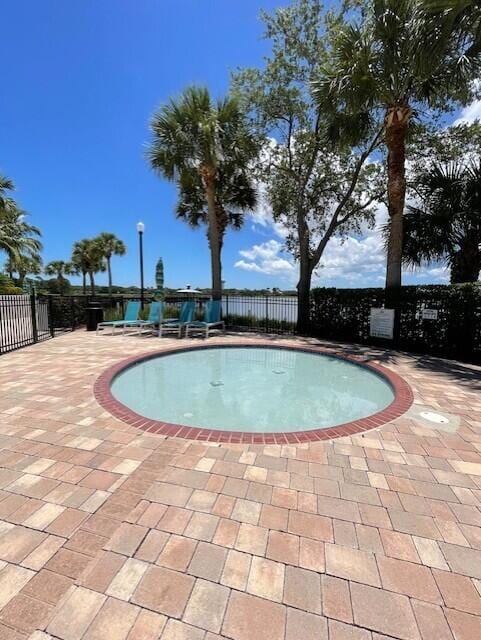 203 Evergrene Pkwy, Palm Beach Gardens, FL 33410 - view of pool featuring fence and a patio