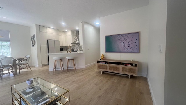 203 Evergrene Pkwy, Palm Beach Gardens, FL 33410 - living room with light wood-type flooring, baseboards, and recessed lighting