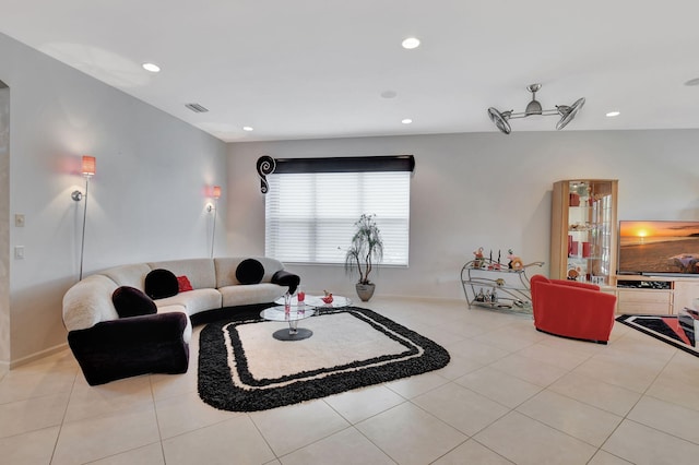 living area featuring recessed lighting and light tile patterned floors